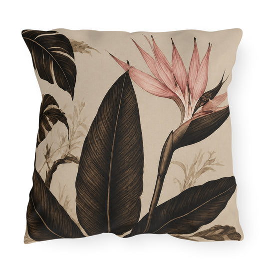 A square decorative throw pillow featuring a botanical print with large dark brown leaves and a pink bird of paradise flower on a warm beige background.