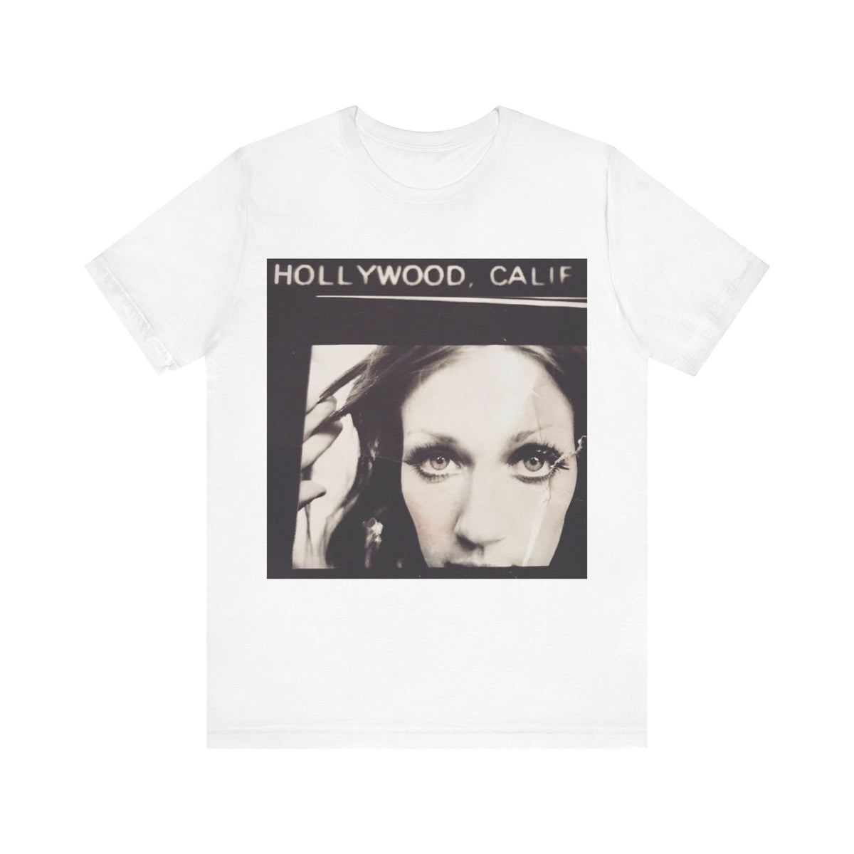 A white short-sleeve crewneck t-shirt featuring a square graphic print on the front with the text 'HOLLYWOOD, CALIF' above a black-and-white portrait of a woman.