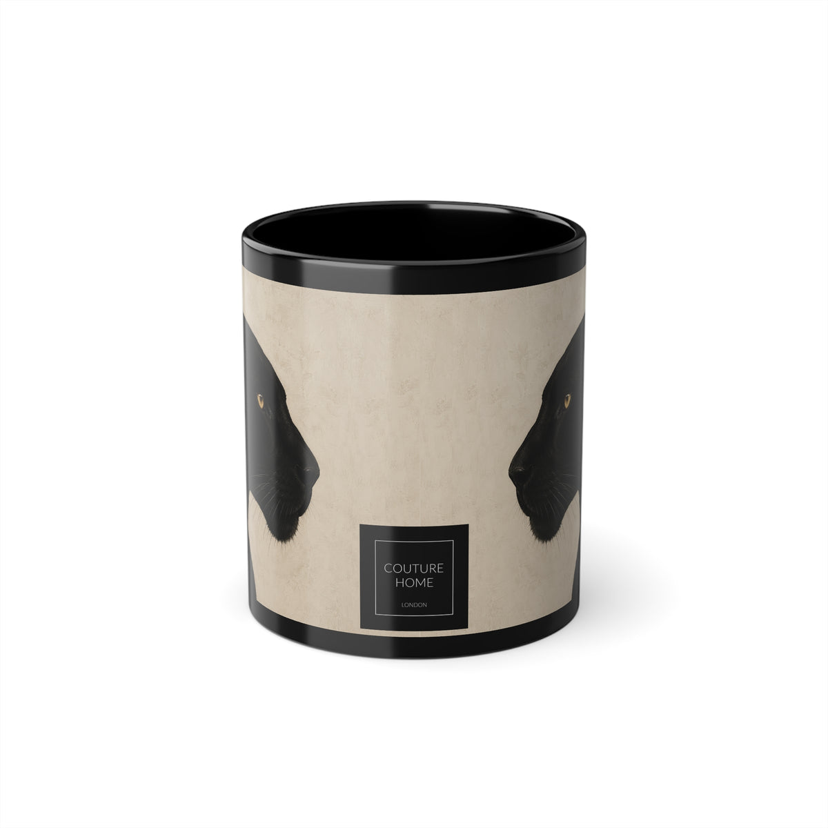 A cylindrical mug with a black rim and interior, featuring a beige wraparound print with two black panther head profiles facing inward and a small black label near the bottom that reads 'COUTURE HOME LONDON'.