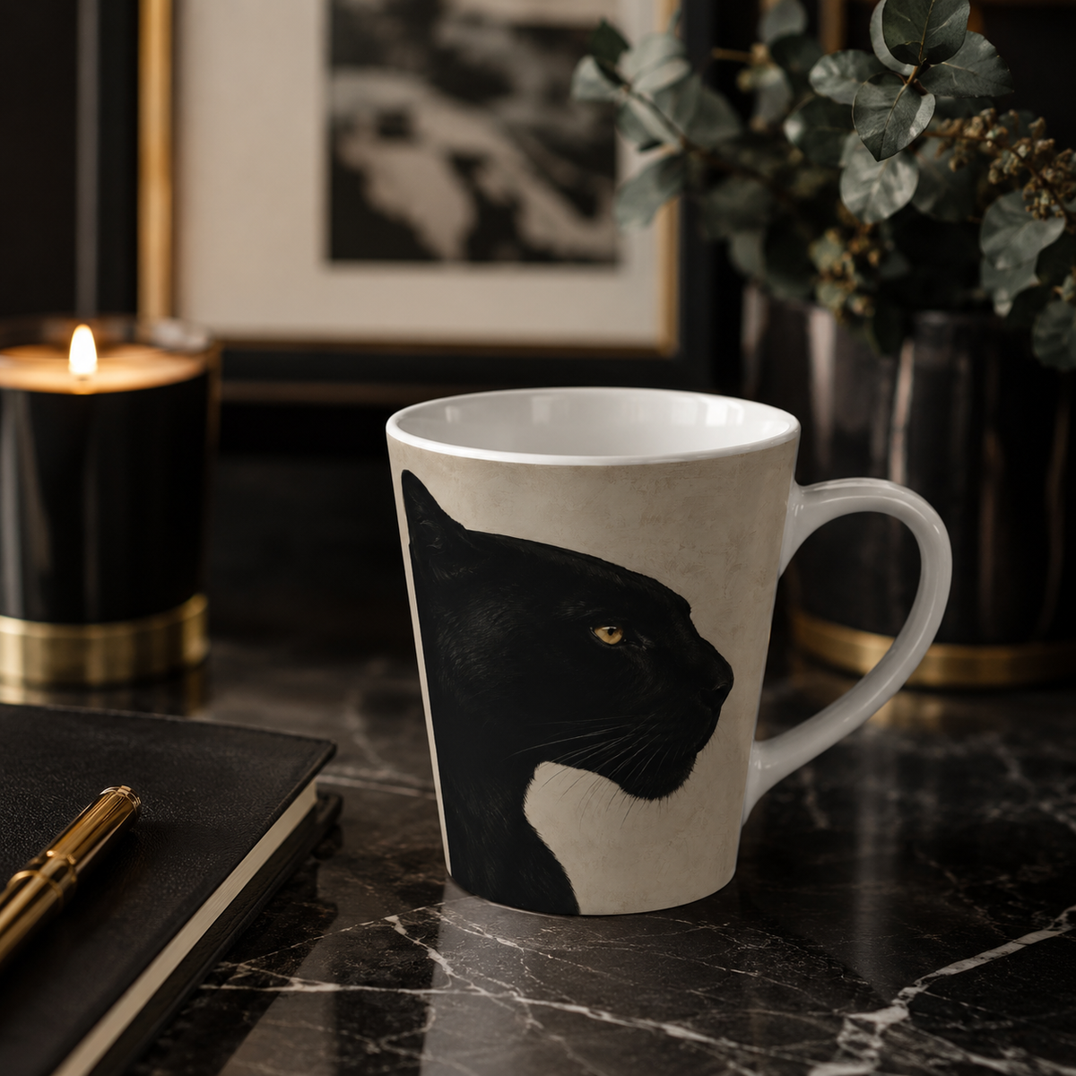 A white ceramic mug with a black panther illustration, set on a dark marble tabletop next to a lit candle, notebook, and greenery in a moody interior setting.