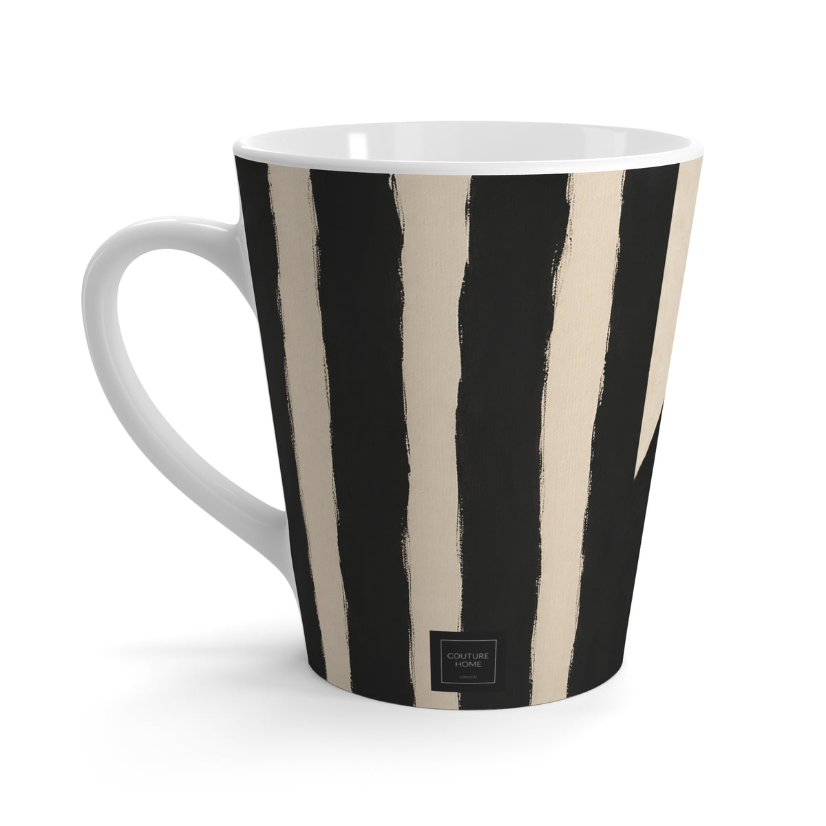 A white ceramic mug with a bold black and beige vertical brushstroke pattern, featuring a small black brand label at the bottom.