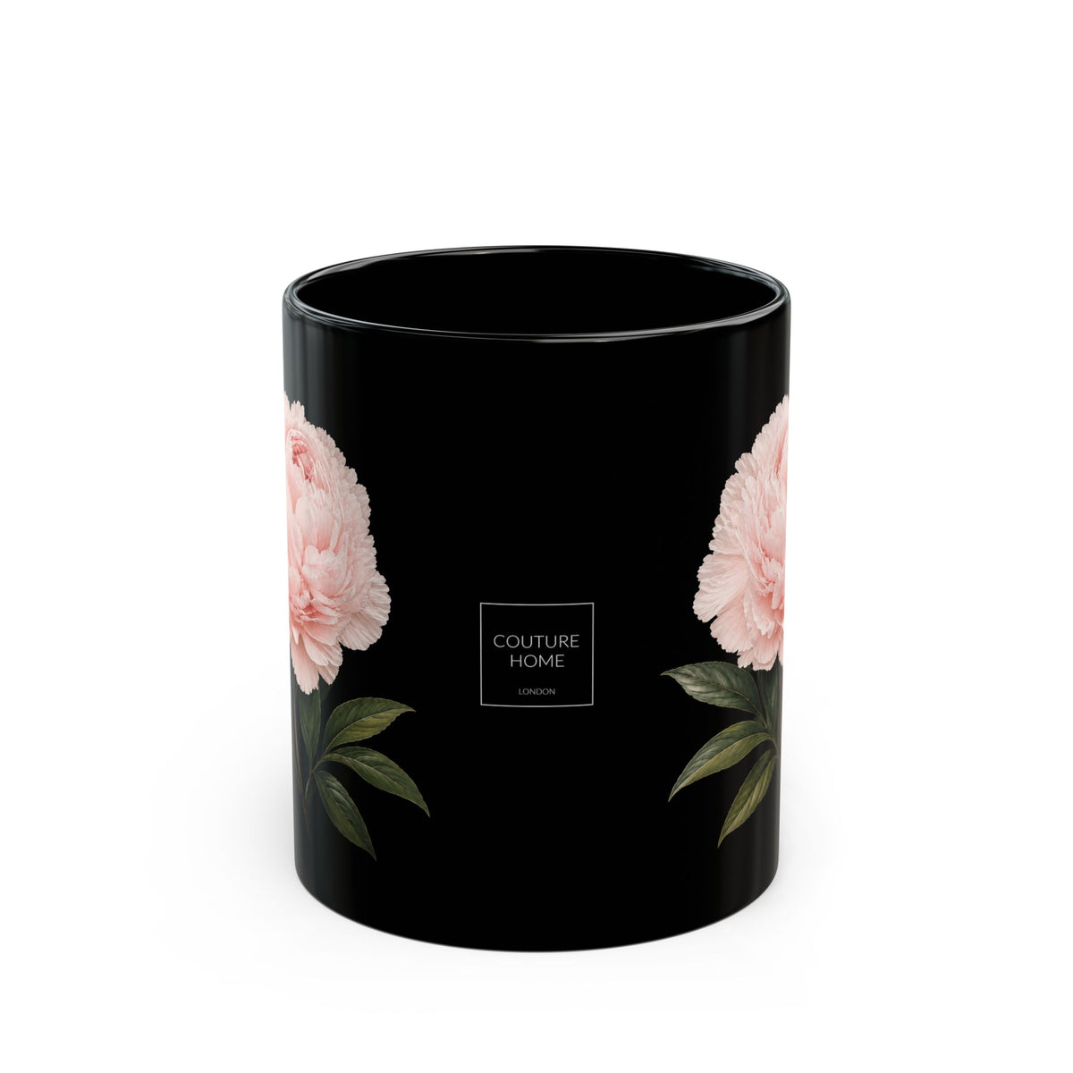 A black cylindrical mug with a glossy finish, decorated with pink peony flowers and green leaves on both sides, featuring a central white square logo that reads 'COUTURE HOME LONDON'.